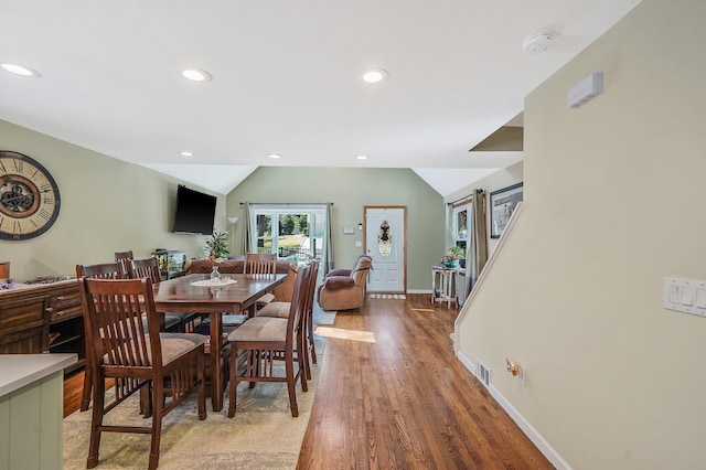 dining space with recessed lighting, baseboards, vaulted ceiling, and light wood finished floors