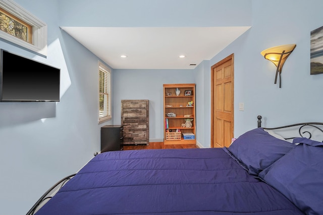 bedroom featuring recessed lighting and wood finished floors