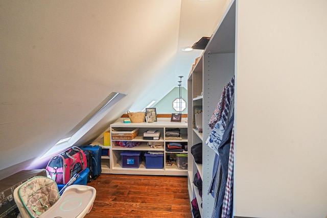 recreation room with wood finished floors and vaulted ceiling