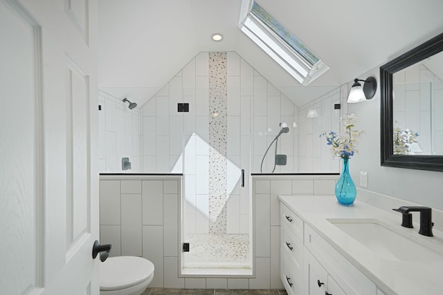 full bathroom featuring vanity, lofted ceiling with skylight, walk in shower, and toilet