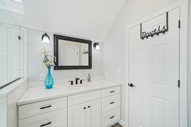 bathroom with vanity and lofted ceiling