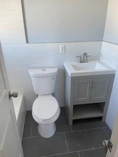 bathroom featuring vanity, tile patterned floors, and toilet