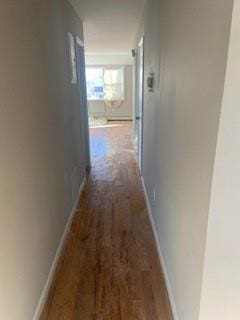 corridor with baseboards and dark wood-style floors