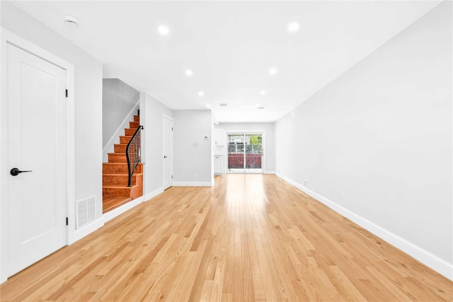 unfurnished living room with visible vents, recessed lighting, baseboards, stairs, and light wood-style flooring