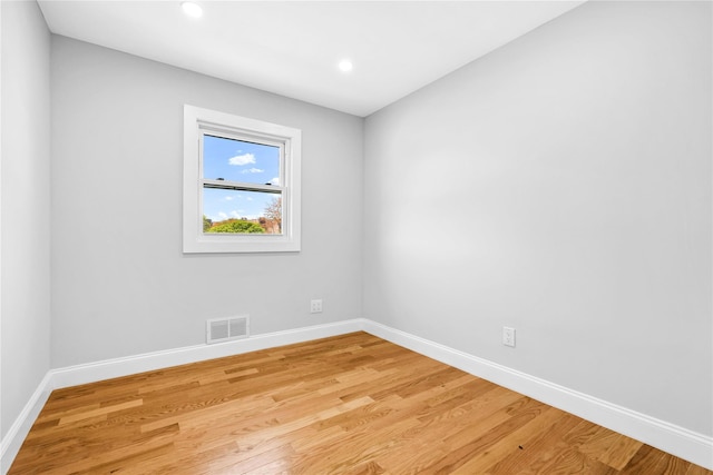 empty room with recessed lighting, baseboards, visible vents, and light wood-type flooring