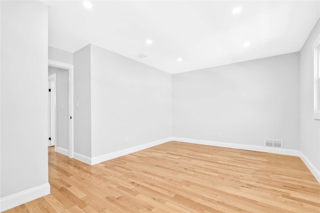 empty room with recessed lighting, baseboards, visible vents, and light wood-type flooring