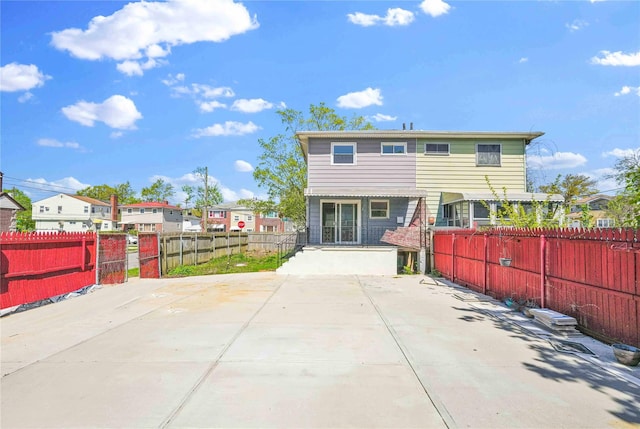 rear view of property with a residential view and fence private yard