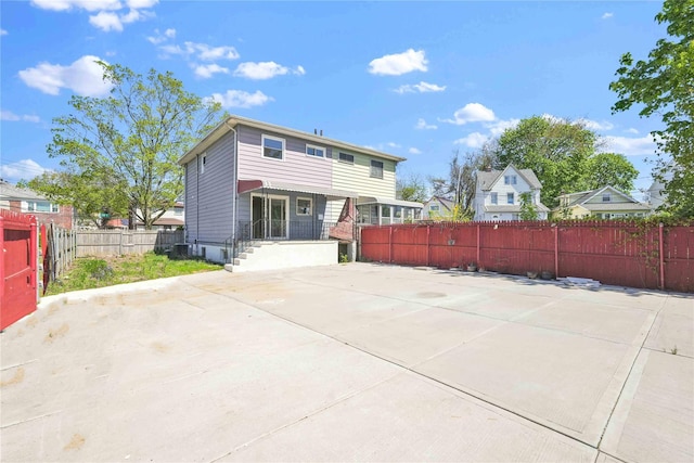rear view of house featuring fence