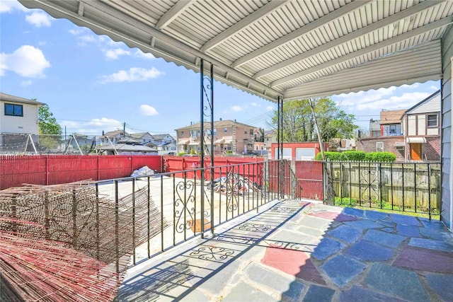 view of patio / terrace with a fenced backyard, a gate, and a residential view