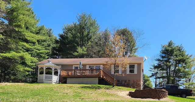 view of front of home with a gazebo, a front yard, and a deck