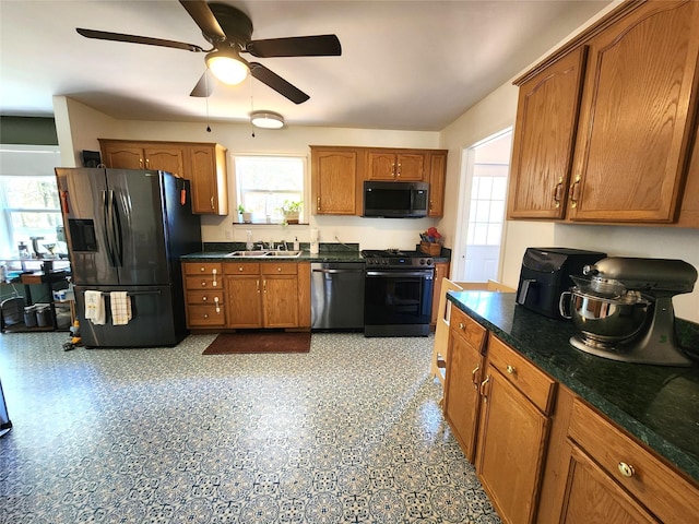 kitchen featuring a sink, dishwasher, range, a ceiling fan, and black fridge with ice dispenser