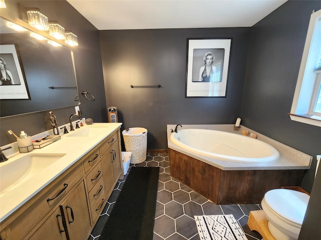 bathroom with a sink, double vanity, toilet, tile patterned floors, and a garden tub