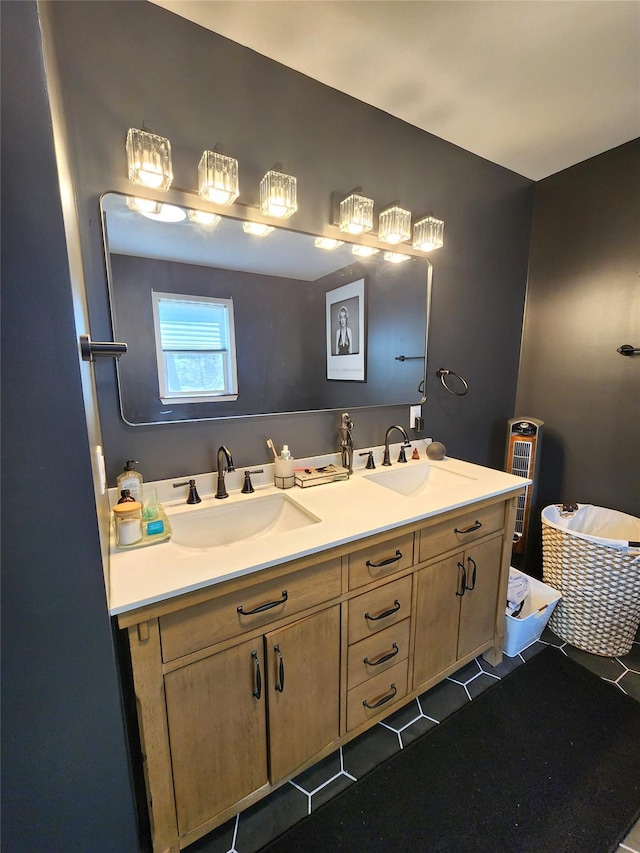 full bath featuring double vanity, tile patterned floors, and a sink