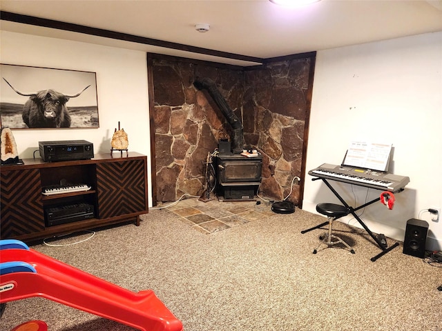 misc room featuring carpet floors and a wood stove