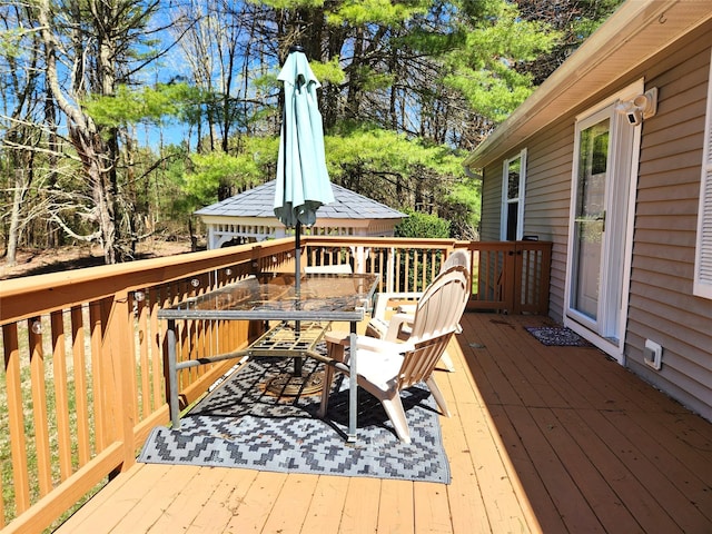 wooden terrace with outdoor dining area
