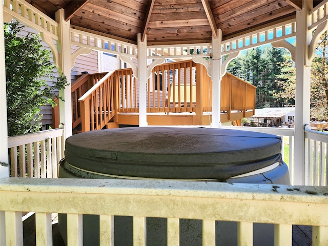 deck featuring a covered hot tub