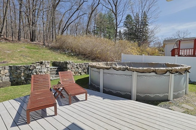 deck featuring a covered pool