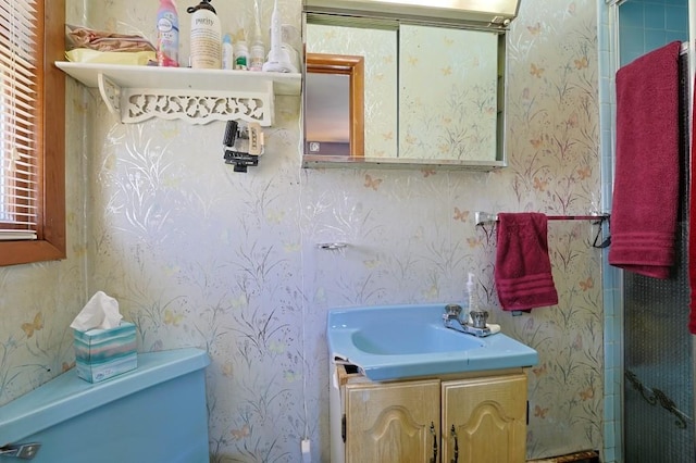 bathroom featuring wallpapered walls and vanity