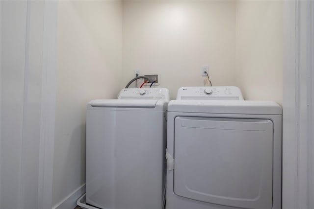 washroom with separate washer and dryer and laundry area