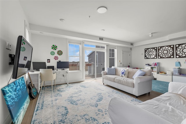 living room with visible vents and wood finished floors