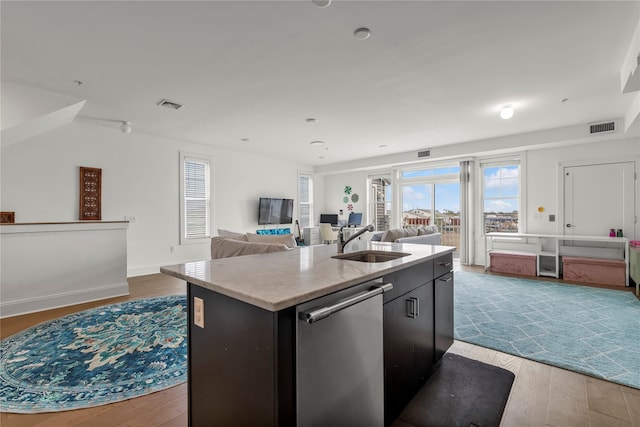 kitchen featuring open floor plan, visible vents, a sink, and dishwasher