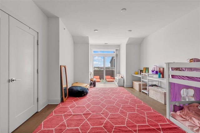 bedroom featuring baseboards and wood finished floors