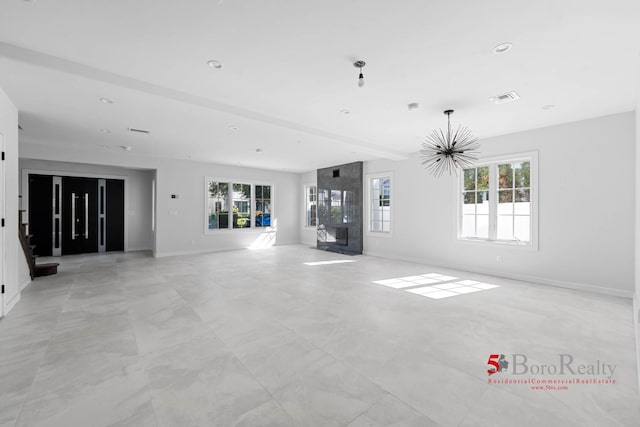 unfurnished living room featuring baseboards and visible vents