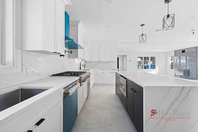 kitchen featuring stainless steel dishwasher, white cabinets, light stone counters, a sink, and backsplash