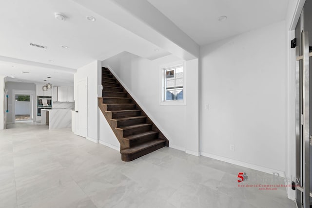 interior space featuring visible vents, recessed lighting, baseboards, and a notable chandelier
