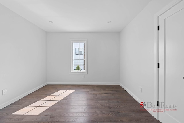 empty room with baseboards and wood finished floors