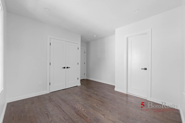 interior space with baseboards, a closet, and wood finished floors