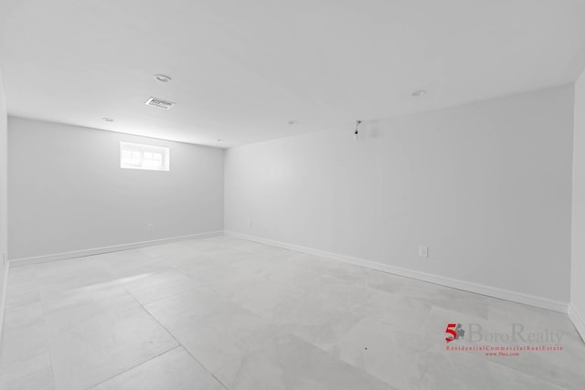 empty room with baseboards and visible vents