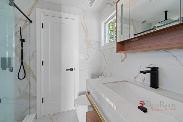 bathroom with vanity, marble finish floor, a marble finish shower, and toilet