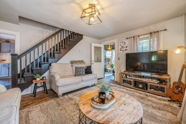 67 Summers St, Oyster Bay, NY 11771 - living area featuring stairway, wood finished floors, and a chandelier