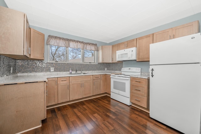 kitchen with a sink, light brown cabinets, white appliances, and dark wood finished floors