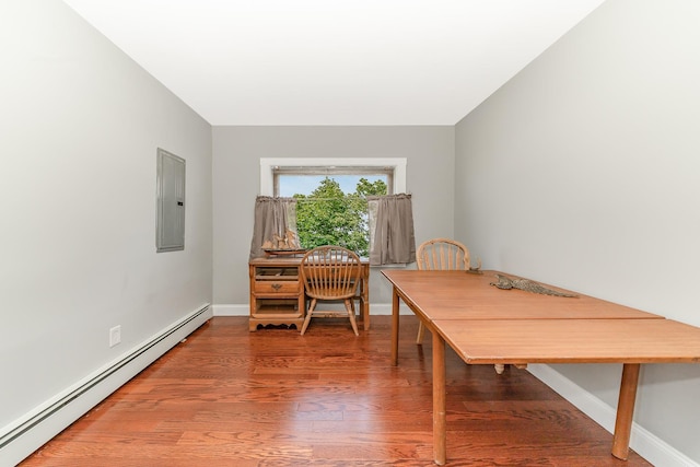 dining space featuring baseboards, light wood finished floors, electric panel, and a baseboard radiator