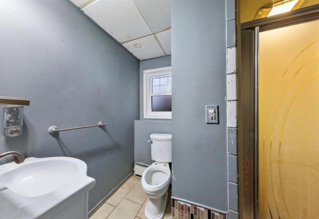 51 Graham St, Farmingdale, NY 11735 - bathroom with a paneled ceiling, tile patterned flooring, a sink, a baseboard radiator, and toilet