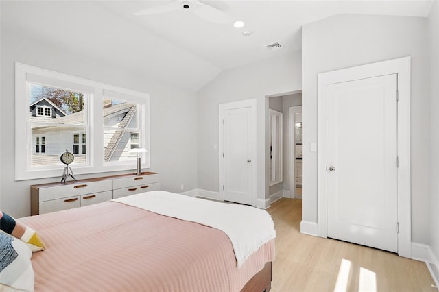 bedroom featuring lofted ceiling, light wood finished floors, and baseboards