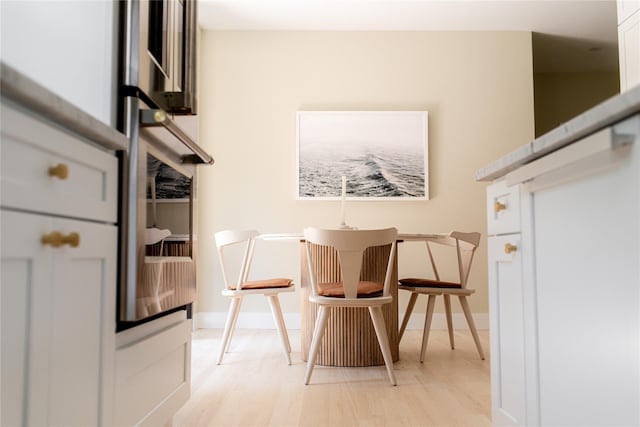 sitting room featuring baseboards and light wood-style flooring