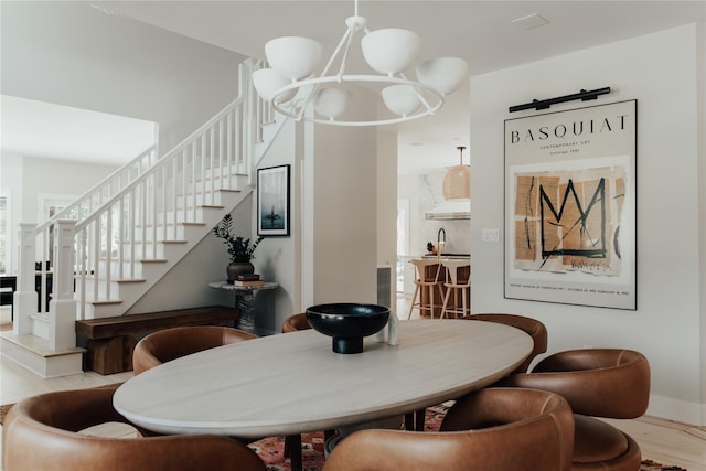 dining space featuring stairs, a barn door, and wood finished floors
