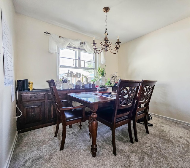 dining space featuring baseboards, carpet, and a notable chandelier