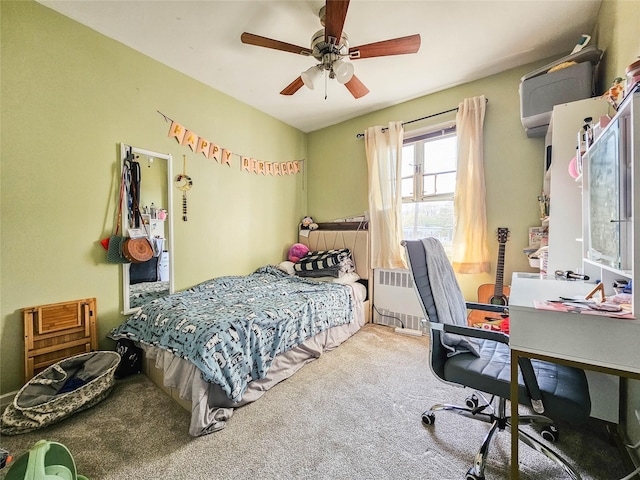 carpeted bedroom featuring ceiling fan and radiator heating unit
