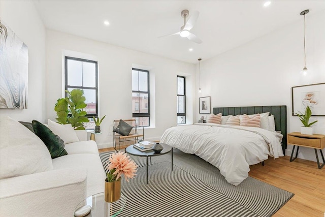bedroom featuring recessed lighting, light wood-style flooring, and multiple windows