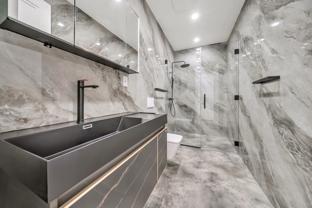bathroom featuring vanity, toilet, tile walls, recessed lighting, and a marble finish shower