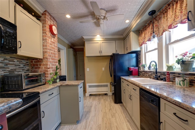 405 Linden St, Bellmore, NY 11710 - kitchen featuring crown molding, an ornate ceiling, radiator heating unit, a sink, and black appliances