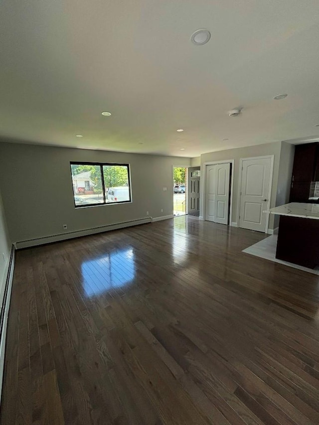 177-37 115th Ave, Saint Albans, NY 11434 - unfurnished living room with dark wood-type flooring, baseboards, recessed lighting, and a baseboard radiator
