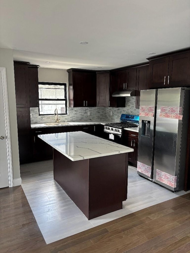 177-37 115th Ave, Saint Albans, NY 11434 - kitchen featuring appliances with stainless steel finishes, a sink, a center island, decorative backsplash, and light stone counters