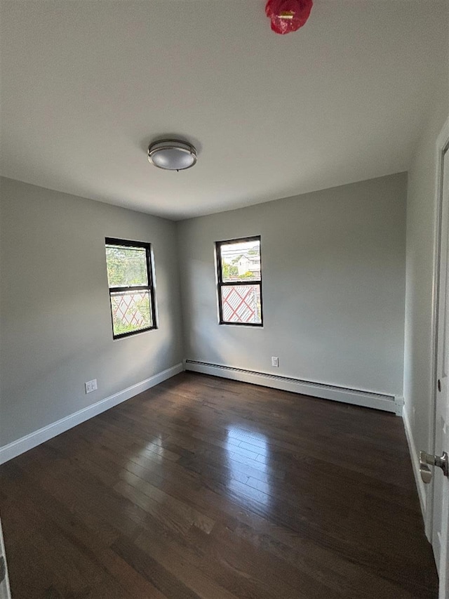 177-37 115th Ave, Saint Albans, NY 11434 - spare room with a baseboard heating unit, healthy amount of natural light, dark wood-style flooring, and baseboards
