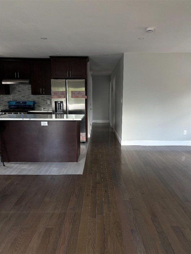 177-37 115th Ave, Saint Albans, NY 11434 - kitchen featuring baseboards, dark wood-style floors, under cabinet range hood, backsplash, and stainless steel fridge with ice dispenser
