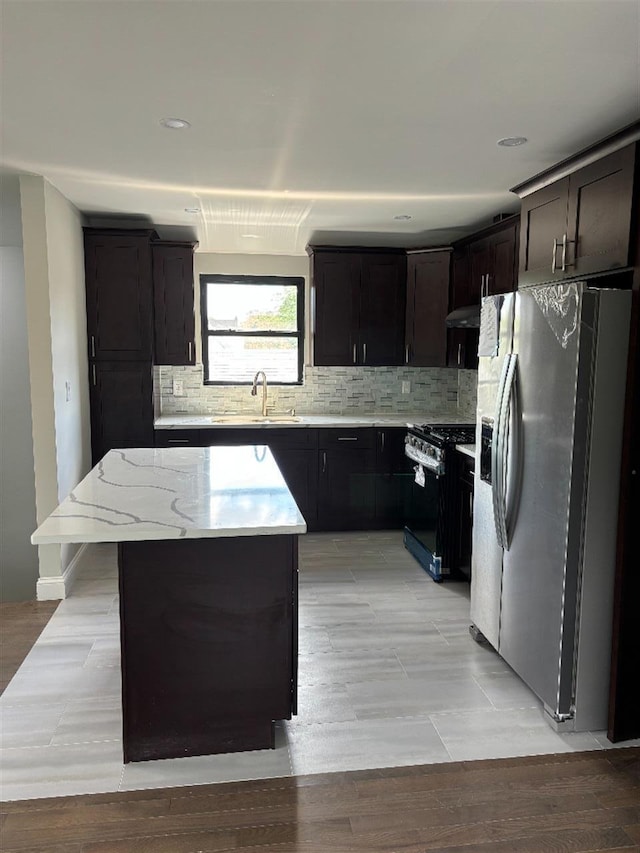 177-37 115th Ave, Saint Albans, NY 11434 - kitchen featuring stainless steel fridge, black range with gas cooktop, a sink, backsplash, and a kitchen island